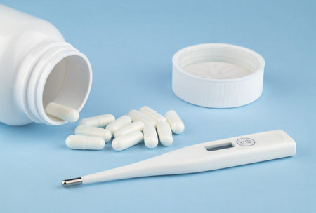 Different drugs and health supplement pills poured from a medicine white bottle health care and...