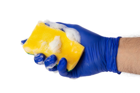 Sponge for washing and cleaning in male hand. Hand in a latex glove isolated on white. A hand in a...