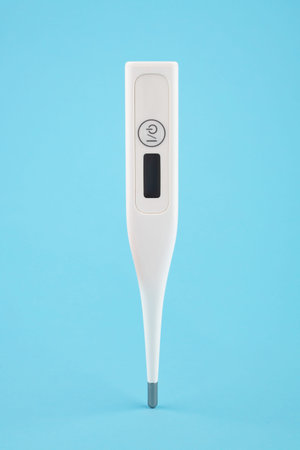 Digital thermometer levitating on a blue background.