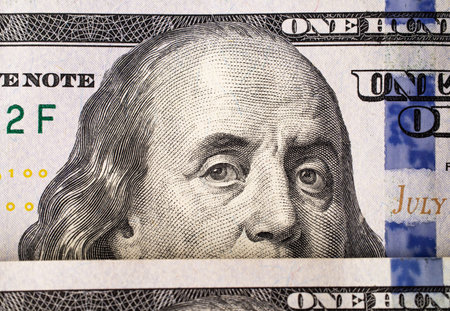 Extreme close-up of one hundred bill Franklin portrait. macro. american paper money. A $100 bill with focus on Benjamin Franklin. US banknotes close-up.の写真素材