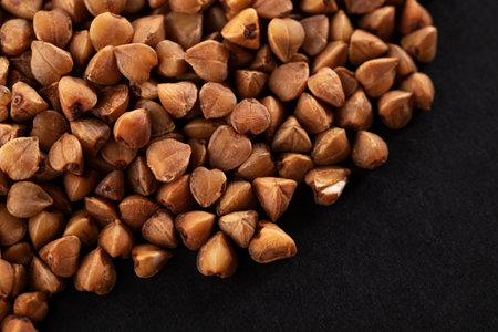 Buckwheat groats on a black background. macro. close-upの写真素材