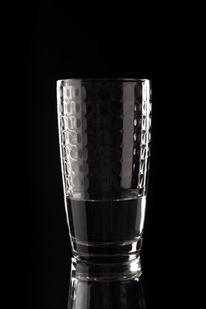 A glass of water on a black background.の写真素材