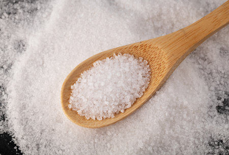 Salt on the wooden spoon. Crystals of salt macro.の写真素材