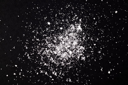 Macro crystals of salt on a black background. Extra close up.の写真素材
