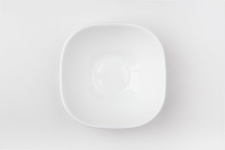An empty white bowl on a white background. Blank plate. Top view.の写真素材