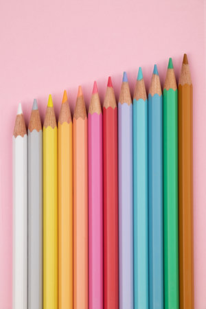 Colored pencils of pastel colors on a pink background. Multi-colored pastel pencils.の写真素材