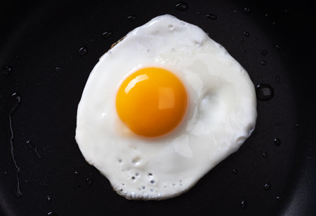 Fried egg in a frying pan. Simple breakfast. Close up.の写真素材