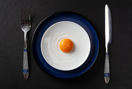 Egg yolk on the plate. Abstract fried eggs. Close up.の写真素材