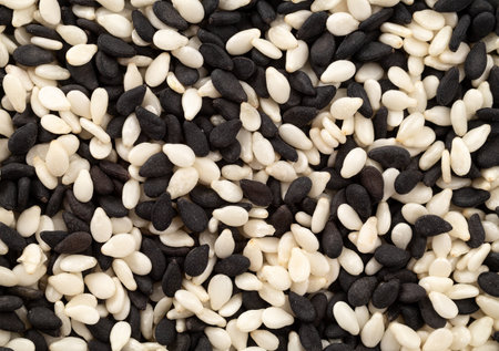 Pile of black and white sesame seeds as background, top view. Macro. Extreme close up.の写真素材