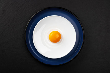 Egg yolk on the plate. Abstract fried eggs. Close up.の写真素材