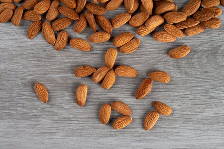 Almonds on a gray wooden background.の写真素材