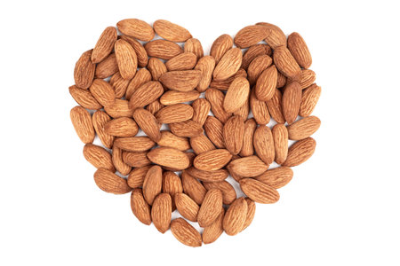Almond heart on a white background. I love almonds. Healthy snack with nuts.の写真素材