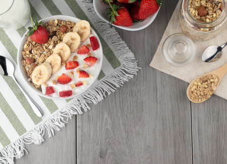 Healthy breakfast with muesli, strawberries and banana on wooden tableの写真素材