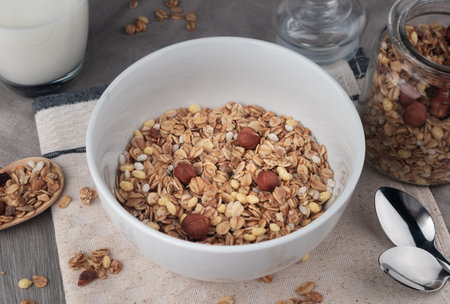 Healthy breakfast - muesli with nuts in a white bowl.の写真素材