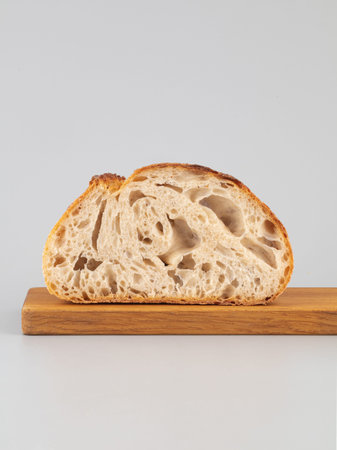 Tartine bread on wooden board isolated on grey background.