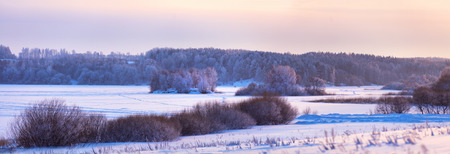 Winter evening on a lake. Frost, ice and snow in Belarusの写真素材