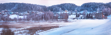 Winter town. January evening. Winter fog in Belarusの写真素材