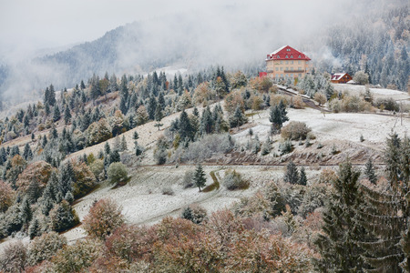Hotel in mountains. Snow and fog. Winter coming in Carpathians.の写真素材