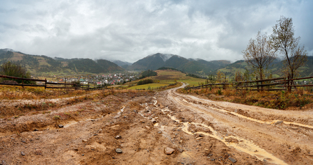 Muddy ground after rain in Carpathian mountains. Extreme path rural dirt road in the hillsの写真素材