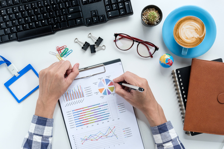 Business man hands working with financial data on office desk table .View from above.Business analysis and strategy concept.の写真素材
