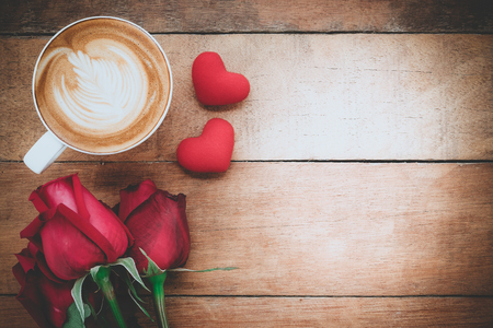 Red rose, heart and cup of coffee on wooden background with copy space.Valentines Day background concept, Wedding day.Top view vintage toneの写真素材