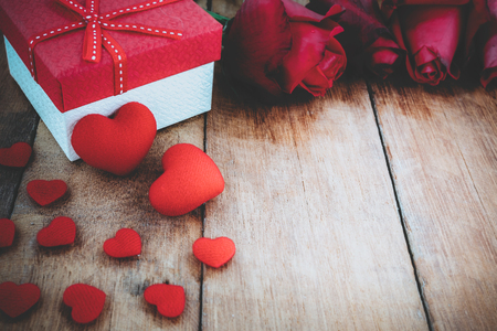 Close up heart, red rose and gift box on wooden board with copy space.Valentines Day background concept, Wedding day.Vintage toneの写真素材