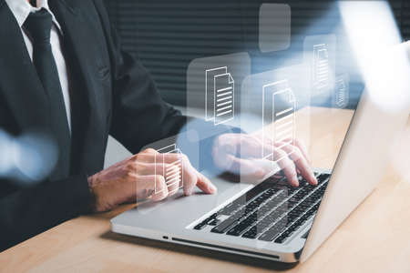 Businessman hand using laptop computer with document management icon, Document management data system business internet technology concept.の写真素材