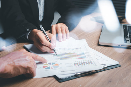 Business team analyzing income charts and graphs with modern laptop computer. Business analysis and strategy concept.の写真素材