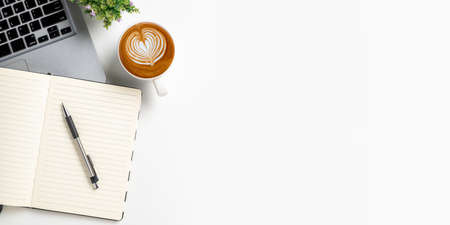 Office desk with computer, Pen, eyeglass, notebook, Cup of coffee on white background, Top view with copy space, Mock up.の写真素材