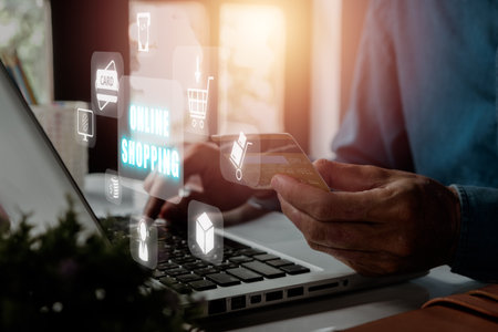 Online shopping concept, Person hands holding credit card and using laptop. with online shopping icon on virtual screen.の写真素材