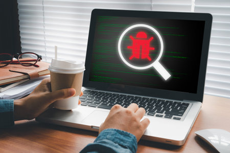 Software development and debugging concept, Person hand using laptop computer with bug software icon...