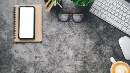 Flat lay, Top view with keyboard computer, blank screen smart phone, notebook, eyeglass, mouse and coffee, Top view with copy space, Mock up.の写真素材