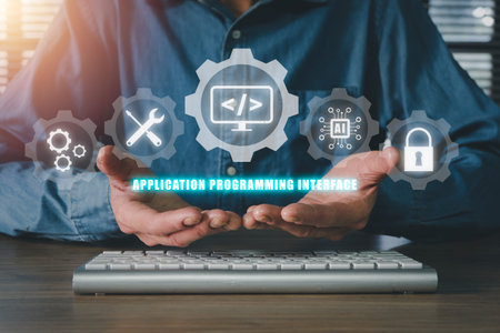 API - Application Programming Interface, Man hand holding VR screen API icon on office desk,...