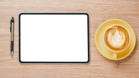 Office wooden desk workplace with blank screen tablet, pen and cup of coffee, Top view flat lay with...