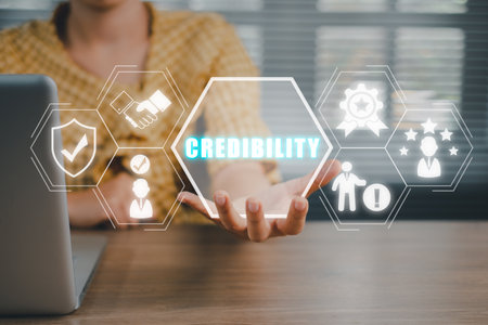 Corporate credibility improvement concept, Business person hand holding credibility icon on virtual screen.の写真素材