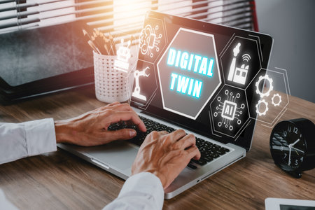 Digital twin business and industrial process modelling, Businessman working on laptop with digital twin icon on virtual screen, innovation and optimisation.の写真素材