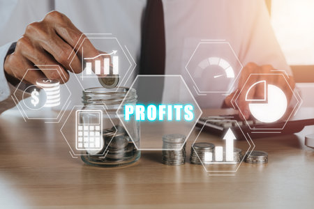 Profit growth, increase profit, raise profit or business growth concept, Businessman putting coin on glass jar with profits icon on virtual screen.の写真素材
