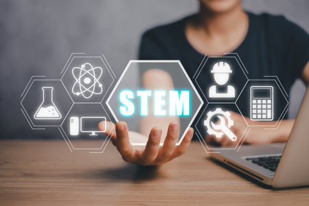 STEM concept, science, technology, engineering, mathematics, Business person hand holding STEM icon on virtual screen.の写真素材