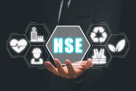 Health safety environment, HSE education industry Concept, Man hand holding health safety environment icon on virtual screen.の写真素材