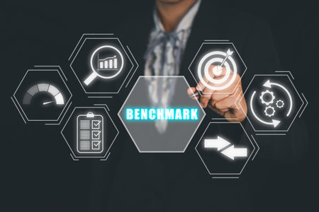 Business concept of benchmark, Business person hand holding pen and touching benchmark icon on virtual screen, Business, Technology, Internet and network.の写真素材