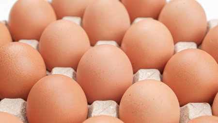 Chicken eggs in carton box on wooden table, Close upの写真素材