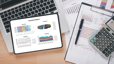 ablet with charts and reports on office desk workplace. Top view flat lay.