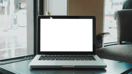 Blank screen laptop computer set up for work on white wooden desk, Mockup, Empty screen, Blank screen for product display.の写真素材
