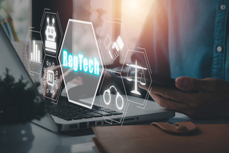 RegTech, Regulation Compliance financial control modern internet technology concept, Person working on laptop computer with RegTech icon on virtual screen.の写真素材