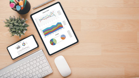 Tablet with charts and reports on office desk workplace. Top view flat layの写真素材