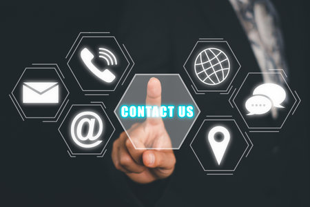 Contact us concept, Business person hand touching contact icon on virtual screen.の写真素材