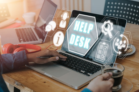 Communication Service Help Desk Concept, Person working on laptop computer with Help desk icon on virtual screen.の写真素材