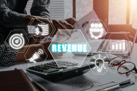 Revenue concept, Business team analyzing income charts and graphs with revenue icon on virtual screen.の写真素材