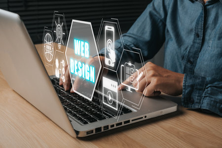 Web design concept, Person using laptop computer with web design icon on virtual screen.の写真素材