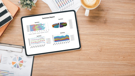 Tablet with charts and reports on office desk workplace. Top view flat layの写真素材